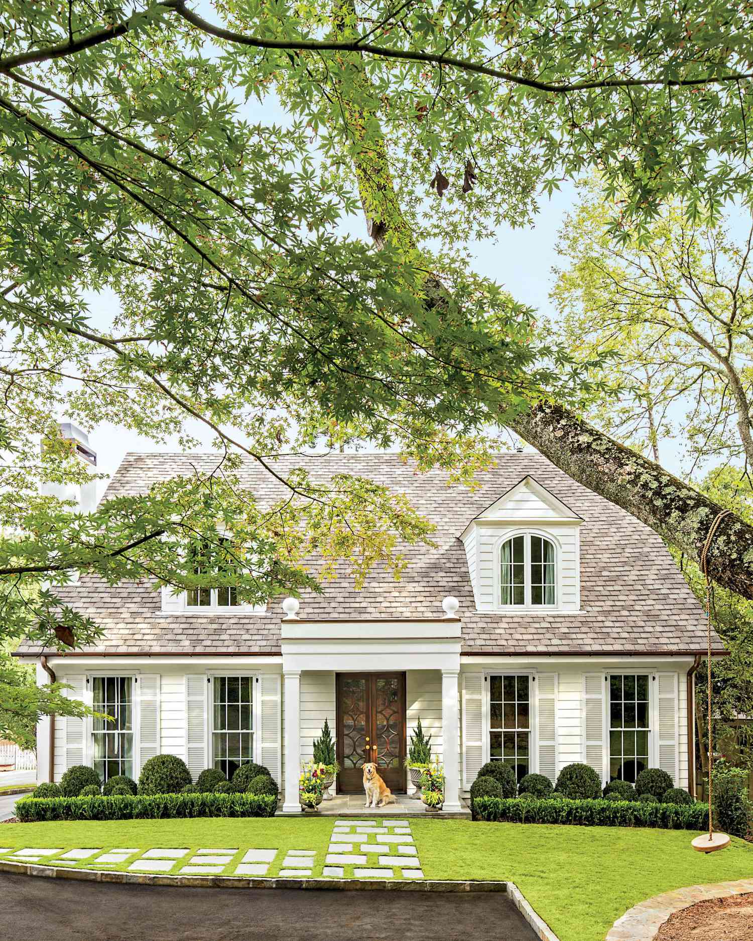 Curb Appeal with Green Hedges and Stone Path