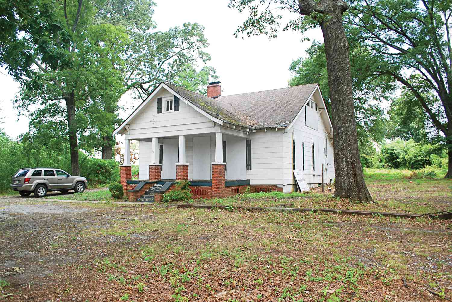 Boarded Up White Bungalow